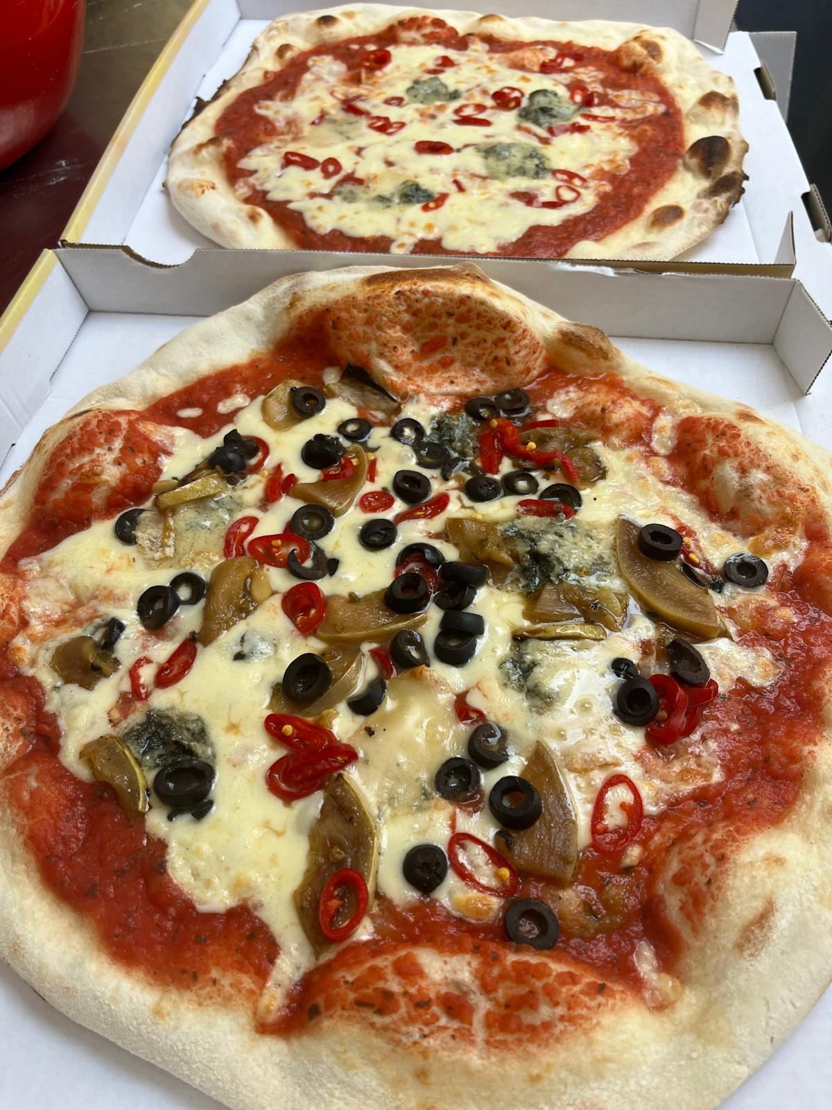 Dwie pizze z oliwkami i papryczkami piccante